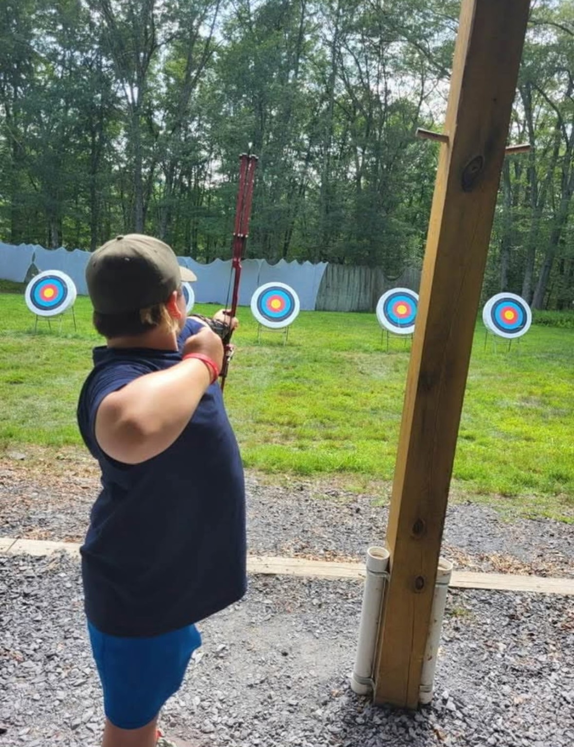 A Troop 288 Scout practicing archery at an outdoor range