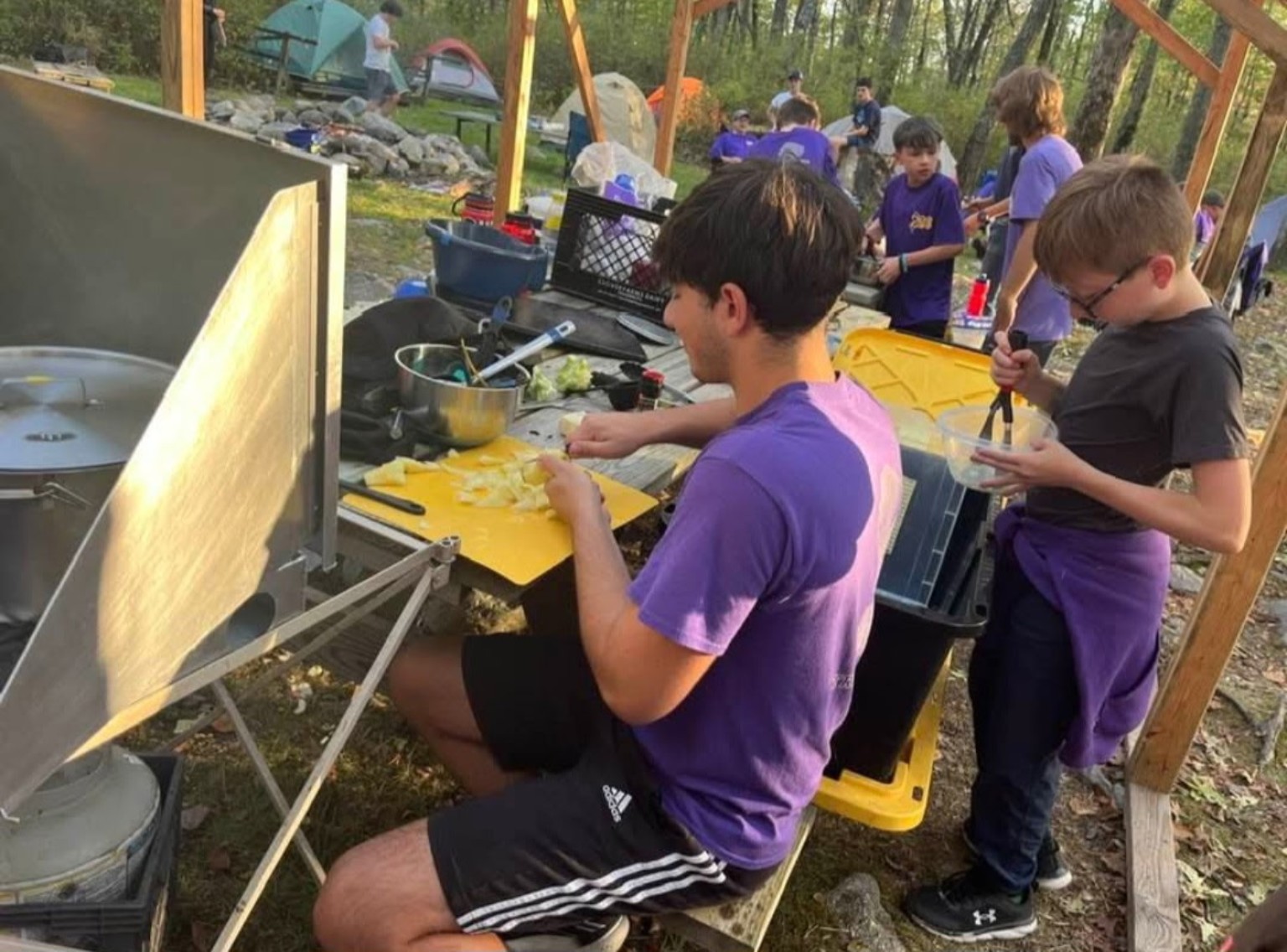 Troop 288 Scouts preparing a meal together at camp